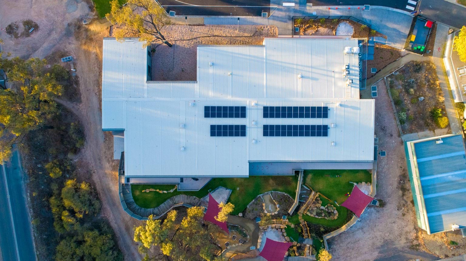 Aerial view of Early Learning Victoria Nyernilang Lar (Eaglehawk North) showing building layout, solar panels on roof, outdoor play areas and surrounding landscape.