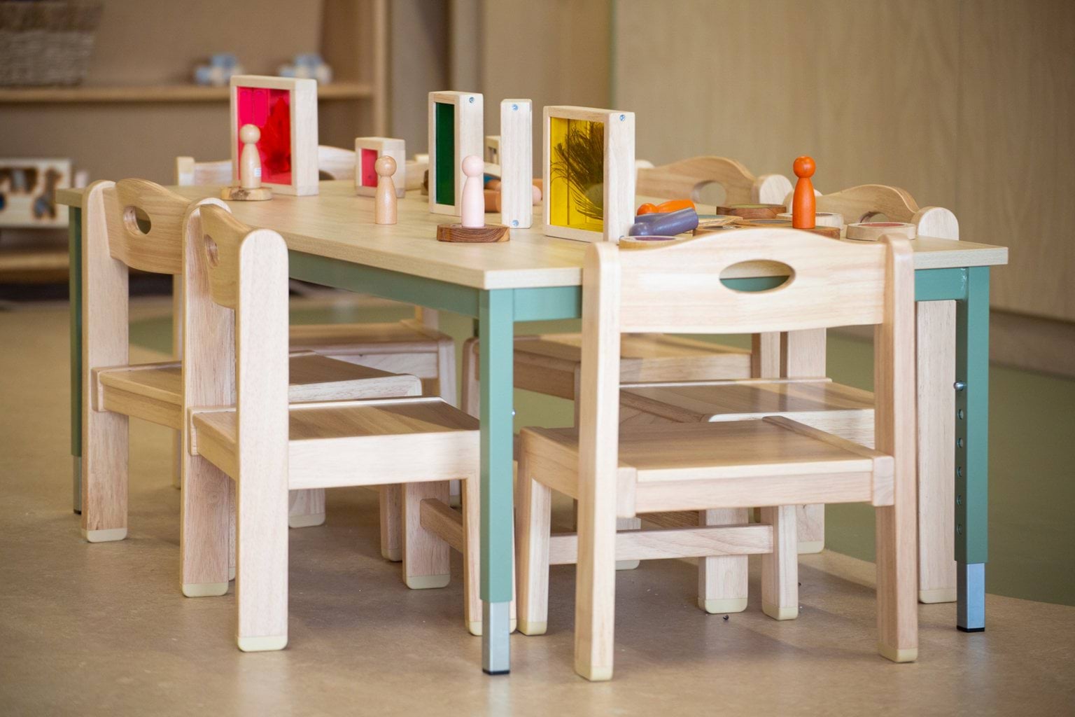 Close-up of timber children’s table and chairs with assorted toys at Early Learning Victoria Wimbi (Fawkner).