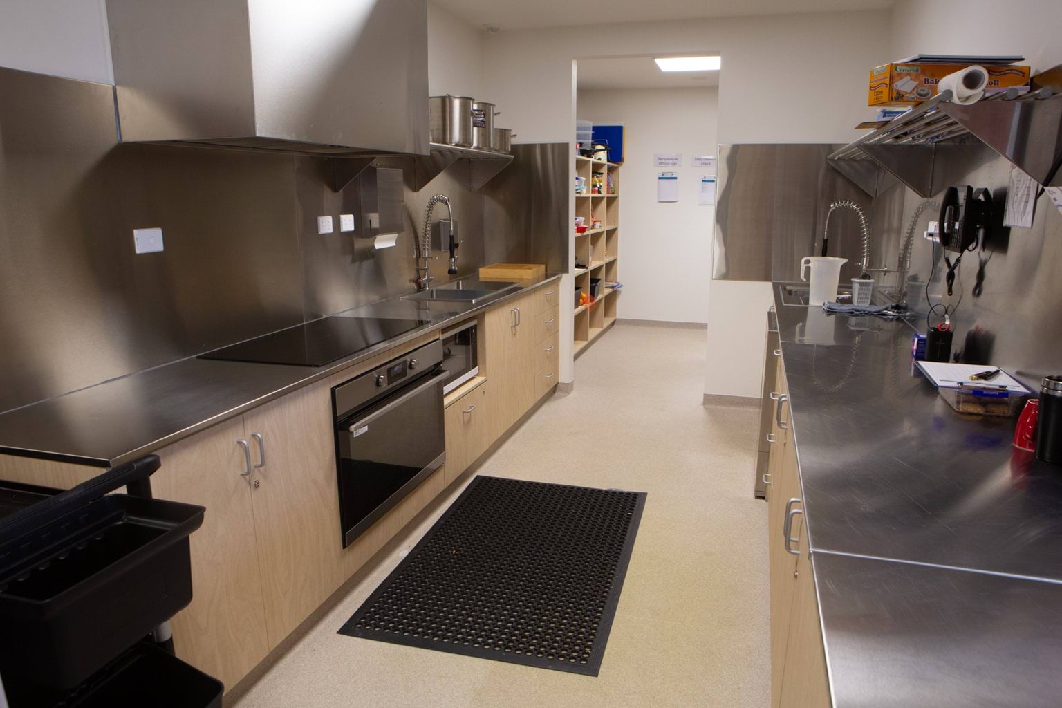 Kitchen at Early Learning Victoria Bani Walup (Murtoa) with bench, sink, cupboards and appliances in view.
