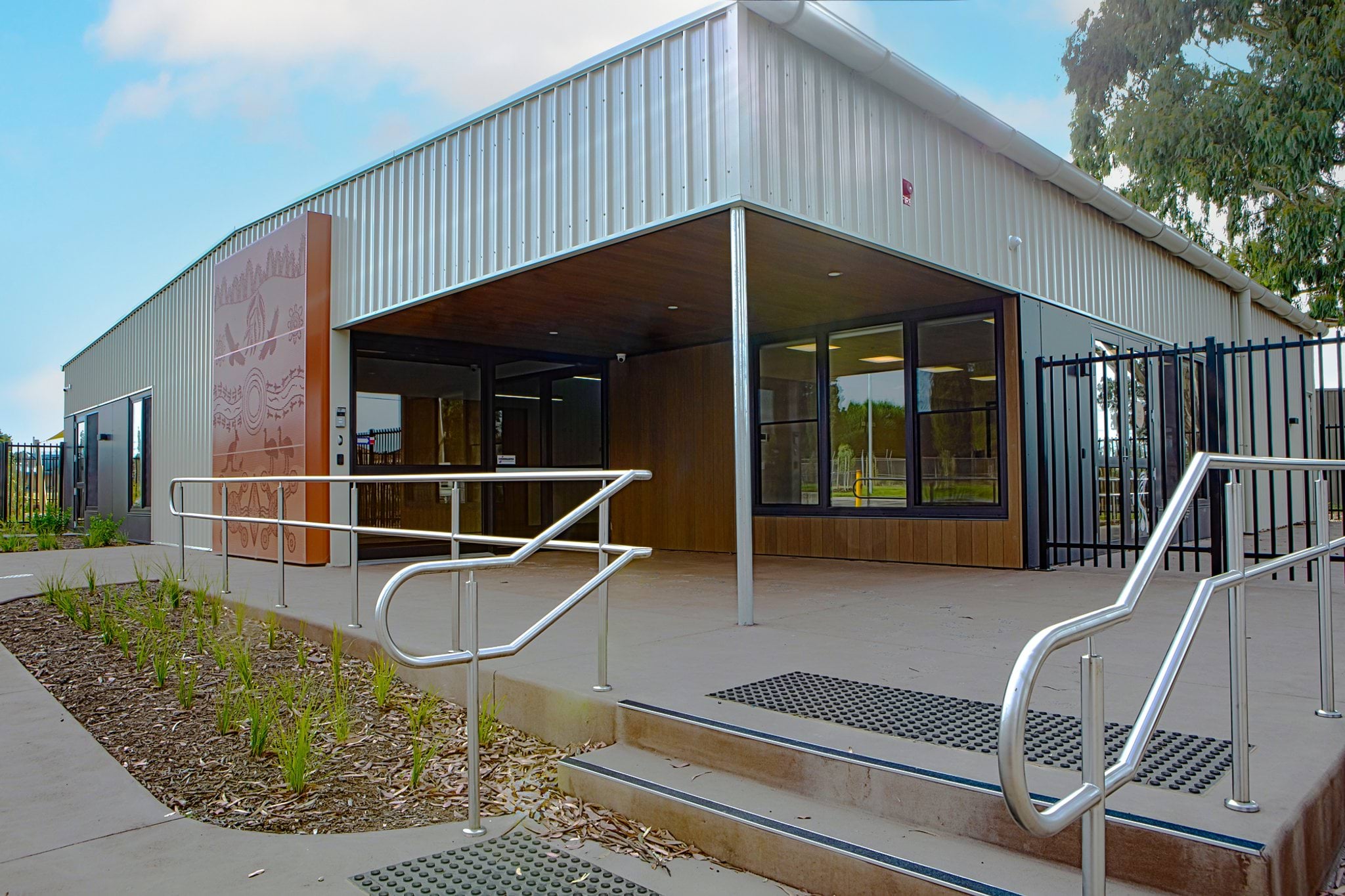 Entrance to Early Learning Victoria Wimbi (Fawkner) with stairs, ramp and modern corrugated iron and timber building.